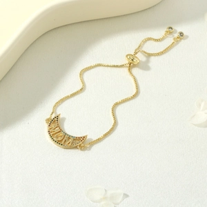 Detail of adjustable gold MOM bracelet with crescent moon and multicolor zircons
