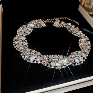 Detailed view of silver choker necklace with sparkling crystals in black jewelry box