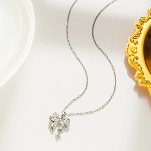 Detailed close-up of a silver butterfly pendant with sparkling cubic zirconia crystals