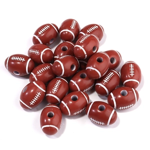 Macro detail of brown rugby shaped acrylic loose beads with white stitching for DIY jewelry