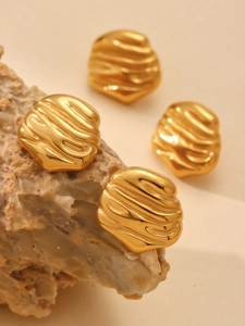 Detailed view of 18K gold plated stainless steel earrings with irregular rippled texture