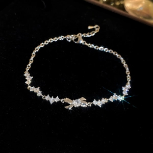Detailed view of silver butterfly bracelet with sparkling zircon stones on black velvet
