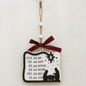 Detail of wooden Christmas sign with nativity silhouette and festive plaid bow