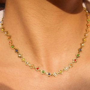 Chic gold-plated stainless steel necklace with colorful floral pendants worn by a model