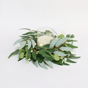 Detail of eucalyptus candle ring with green willow leaves and white pearl berries