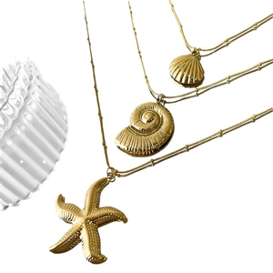 Three-piece gold plated stainless steel ocean theme necklaces with starfish and shell pendants
