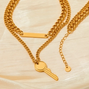 Double-layered gold stainless steel necklace featuring key pendant and rectangular plaque