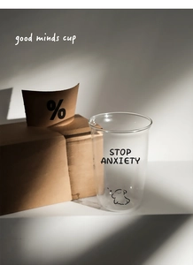 Detail of borosilicate glass cup with STOP ANXIETY cartoon print and minimalist text