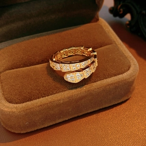 Detailed view of the gold-tone snake ring's scale texture with sparkling white zircons