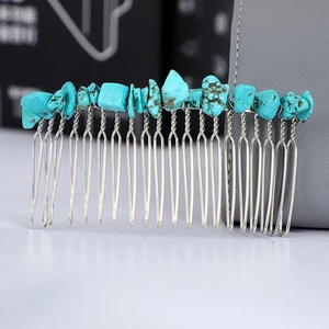 Macro detail of Bohemian silver wire hair comb with natural turquoise stone fragments