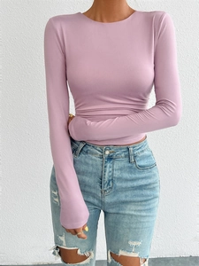 Detail of slim fit purple knit long sleeve top paired with distressed denim jeans