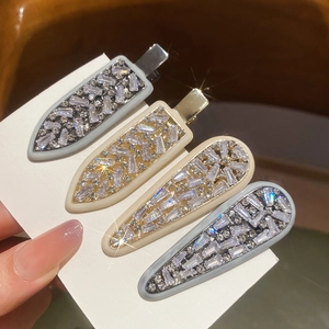 Elegant zircon square arrow hair clips in grey and beige tones on a white display card