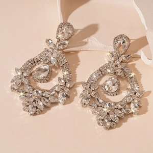 Detail of luxury teardrop silver needle earrings with shimmering crystals for evening events