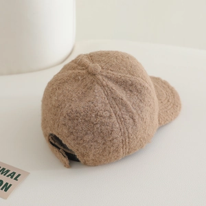Detail view of khaki faux shearling baseball cap showing fuzzy texture and adjustable strap