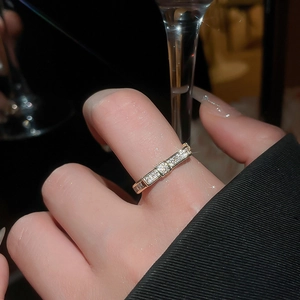 Macro shot of a gold zircon ring with baguette accents worn during a social event
