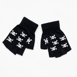 Detail view of black knitted half-finger gloves with white luminous skull print design