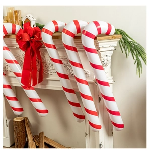 Close-up of inflatable red and white Christmas candy canes decorated with velvet bows