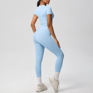 Detailed back view of high-waist baby blue yoga leggings and fitted athletic t-shirt set