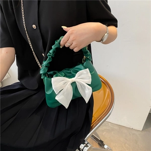 Elegant green cloud bag with white bow knot and gold chain strap in minimalist style