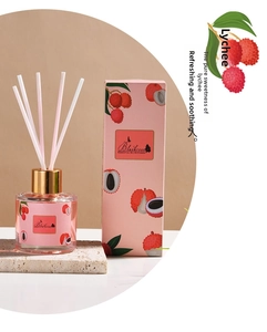 Detailed view of the lychee reed diffuser bottle with pink packaging and aroma sticks