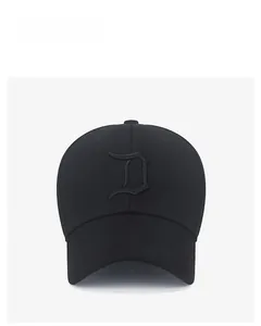 Close-up of black baseball cap with gothic letter D embroidery and six-panel structure