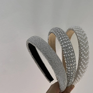 Sparkling rhinestone and pearl headbands in a layered display for an elegant hair accessory look