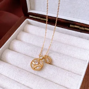 Gold plated starburst pendant necklace with cubic zirconia on a white velvet jewelry box