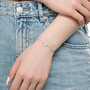 Close-up of S925 sterling silver butterfly bracelet with pave-set zircons on wrist