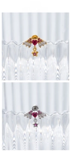 Detail of angel wing heart earrings with star charms in gold and silver finish