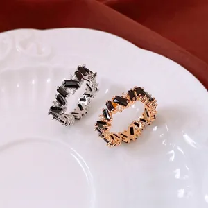 Vintage style rings with black zircon stones in gold and silver finish on white ceramic