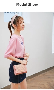 Pink PU leather crossbody bag with mesh pattern and gold clasp shown on a model