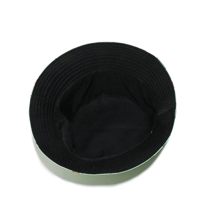 Close-up of black cotton lining and fruit pattern brim on a tropical bucket hat