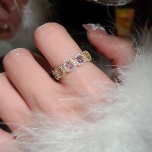 Detailed macro view of 14k gold plated ring with colorful zircon stones and feathers