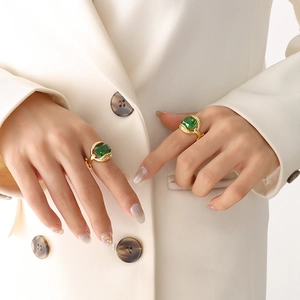 Vintage gold plated titanium steel ring featuring emerald cut green crystal on model