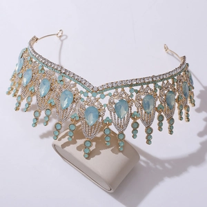 Close-up of Baroque bridal crown with teardrop blue gems and rhinestones on metal base