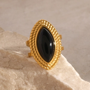 Macro detail of vintage 18k gold plated ring featuring a black marquise onyx stone