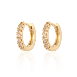 Close-up of gold plated hoop earrings with white zircon inlays and elegant reflections