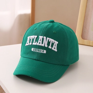 Detail of green kids baseball cap with white Atlanta Georgia letter embroidery