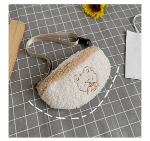 Detail of white fluffy lamb wool chest bag with cute bear embroidery and beige zipper