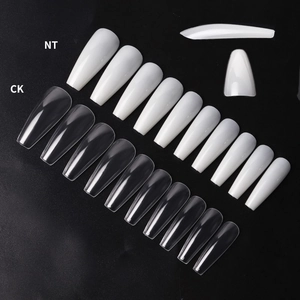 Macro shot of long coffin ballerina false nail tips in clear and natural white colors
