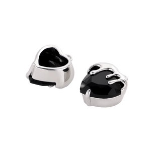 Macro detail of heart-shaped black zircon charms with silver fluid metal flame edges