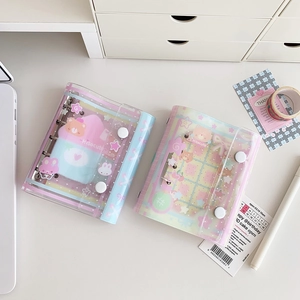 Detail of transparent PVC binder cover with purple snap button and loose-leaf metal rings