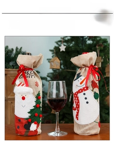 Detailed view of linen Christmas wine bottle bags with Santa and Snowman embroidery