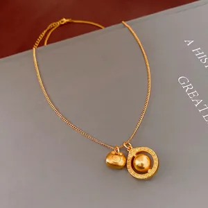 Elegant gold double pendant necklace featuring a lotus bag and circle charm on a thin chain