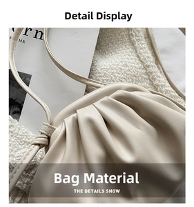 Detailed macro shot of soft pleated PU leather texture on a cream-colored dumpling bag