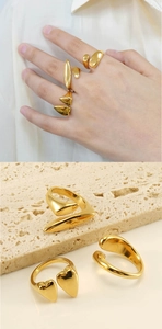 Detail of adjustable 18k gold plated stainless steel rings with heart and drop shapes