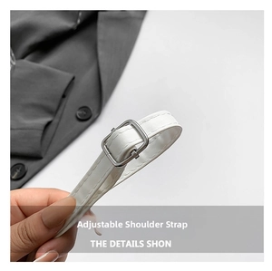 Close-up of the adjustable white leather shoulder strap with a silver metal buckle detail