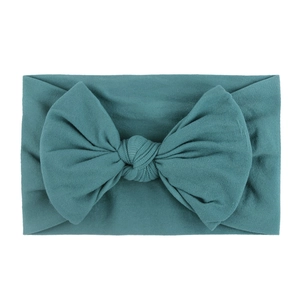 Soft nylon baby headband with a large dark teal knit bow for infants and girls