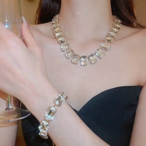 Close-up of sparkling square-cut crystal necklace and bracelet set on a model