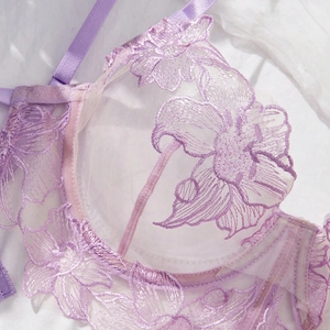Detail of purple lace embroidery and sheer mesh on elegant french style bra